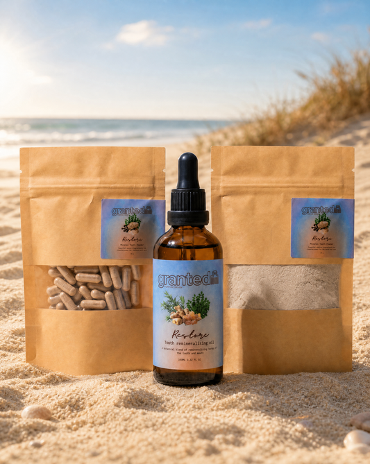 Bottle of Grantea product with two brown packages on a sandy beach